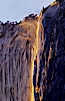 Horsetail Falls backlit by the setting sun as it cascades down the face of El Capitan, February, Yosemite Valley. Horsetail Falls, Yosemite National Park, California, USA. Image #07048