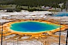 Grand Prismatic Spring (left) and Excelsior Geyser (right).  Grand Prismatic Spring displays a stunning rainbow of colors created by species of thermophilac (heat-loving) bacteria that thrive in narrow temperature ranges.  The blue water in the center is too hot to support any bacterial life, while the outer orange rings are the coolest water.  Grand Prismatic Spring is the largest spring in the United States and the third-largest in the world.  Midway Geyser Basin. Midway Geyser Basin, Yellowstone National Park, Wyoming, USA. Image #13571