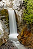 Christine Falls is a 69 foot (21m) waterfall in Mount Rainier.  The lower section of Christine Falls is  known for the bridge that spans across it. Christine Falls, Mount Rainier National Park, Washington, USA. Image #13823