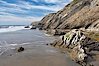 Shale is a fine-grained detrital sedimentary rock formed by the compaction of clay, silt, or mud.  Shale is formed when mud is pressed into rock over millions of years and often breaks into big flat pieces. Here layers of shale emerge from the sand and cliffs at Gaviota State Beach north of Santa Barbara. Gaviota State Beach, Santa Barbara, California, USA. Image #14895