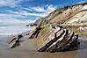 Shale is a fine-grained detrital sedimentary rock formed by the compaction of clay, silt, or mud.  Shale is formed when mud is pressed into rock over millions of years and often breaks into big flat pieces. Here layers of shale emerge from the sand and cliffs at Gaviota State Beach north of Santa Barbara. Gaviota State Beach, Santa Barbara, California, USA. Image #14896