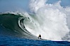 2006 Mavericks surf contest champion Grant Twiggy Baker of South Africa catches one of his many great waves of the day, this one in the first round.  Check out the huge bounce lifting up behind him, heavy.  Mavericks surf contest, February 7, 2006. Mavericks, Half Moon Bay, California, USA. Image #15307