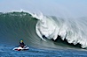 Grant Washburn (fifth place) gives the jetski photographer a show in the early rounds of the Mavericks surf contest, February 7, 2006. Mavericks, Half Moon Bay, California, USA. Image #15309