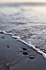 Beach stones, sea water, sand, reflections of sunset. Ponto, Carlsbad, California, USA. Image #17986