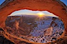 Mesa Arch spans 90 feet and stands at the edge of a mesa precipice thousands of feet above the Colorado River gorge. For a few moments at sunrise the underside of the arch glows dramatically red and orange. Island in the Sky, Canyonlands National Park, Utah, USA. Image #18085