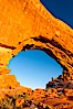 Hiker in North Window, sunset, western face.  North Window is a natural sandstone arch 90 feet wide and 48 feet high. North Window, Arches National Park, Utah, Utah, USA. Image #18159