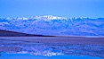 Sunrise lights Telescope Peak as it rises over the salt flats of Badwater, Death Valley.  At 11,049 feet, Telescope Peak is the highest peak in the Panamint Range as well as the highest point in Death Valley National Park.  At 282 feet below sea level, Badwater is the lowest point in North America. Badwater, Death Valley National Park, California, USA. Image #20549
