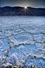 Devils Golf Course. Evaporated salt has formed into gnarled, complex crystalline shapes on the salt pan of Death Valley National Park, one of the largest salt pans in the world.  The shapes are constantly evolving as occasional floods submerge the salt concretions before receding and depositing more salt. Devils Golf Course, Death Valley National Park, California, USA. Image #20552