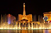 The Bellagio Hotel fountains light up the reflection pool as the half-scale replica of the Eiffel Tower at the Paris Hotel in Las Vegas rises above them, at night. Las Vegas, Nevada, USA. Image #20559
