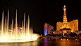 The Bellagio Hotel fountains light up the reflection pool as the half-scale replica of the Eiffel Tower at the Paris Hotel in Las Vegas rises above them, at night. Las Vegas, Nevada, USA. Image #20560