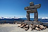 Ilanaaq, the logo of the 2010 Winter Olympics in Vancouver, is formed of stone in the Inukshuk-style of traditional Inuit sculpture.  This one is located on the summit of Whistler Mountain. Whistler, British Columbia, Canada. Image #21014