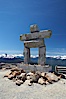 Ilanaaq, the logo of the 2010 Winter Olympics in Vancouver, is formed of stone in the Inukshuk-style of traditional Inuit sculpture.  This one is located on the summit of Whistler Mountain. Whistler, British Columbia, Canada. Image #21015
