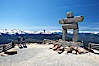 Ilanaaq, the logo of the 2010 Winter Olympics in Vancouver, is formed of stone in the Inukshuk-style of traditional Inuit sculpture.  This one is located on the summit of Whistler Mountain. Whistler, British Columbia, Canada. Image #21018