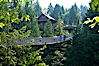 Capilano Suspension Bridge, 140 m (450 ft) long and hanging 70 m (230 ft) above the Capilano River.  The two pre-stressed steel cables supporting the bridge are each capable of supporting 45,000 kgs and together can hold about 1300 people. Capilano Suspension Bridge, Vancouver, British Columbia, Canada. Image #21150