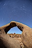 Mobius Arch in the Alabama Hills, seen here at night with swirling star trails formed in the sky above due to a long time exposure. Alabama Hills Recreational Area, California, USA. Image #21732