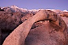 Mobius Arch, the Alabama Hills and the Sierra Nevada Range at sunrise, pink early morning light. Alabama Hills Recreational Area, California, USA. Image #21734