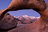 Mobius Arch at sunrise, framing snow dusted Lone Pine Peak and the Sierra Nevada Range in the background.  Also known as Galen's Arch, Mobius Arch is found in the Alabama Hills Recreational Area near Lone Pine. Alabama Hills Recreational Area, California, USA. Image #21736