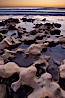 Rocks along the edge of the ocean at sunset. Carlsbad, California, USA. Image #22195