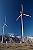 Wind turbines, rise above the flat floor of the San Gorgonio Pass near Palm Springs, with snow covered Mount San Jacinto in the background, provide electricity to Palm Springs and the Coachella Valley. San Gorgonio Pass, Palm Springs, California, USA. Image #22207