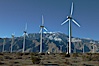 Wind turbines, rise above the flat floor of the San Gorgonio Pass near Palm Springs, with snow covered Mount San Jacinto in the background, provide electricity to Palm Springs and the Coachella Valley. San Gorgonio Pass, Palm Springs, California, USA. Image #22208