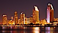 San Diego city skyline at night, showing the buildings of downtown San Diego reflected in the still waters of San Diego Harbor, viewed from Coronado Island. San Diego, California, USA. Image #22250