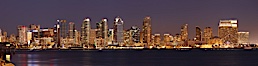 San Diego city skyline at sunset, showing the buildings of downtown San Diego rising above San Diego Harbor, viewed from Harbor Island.  A panoramic photograph, composite of four separate images. San Diego, California, USA. Image #22253
