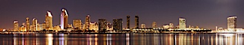 San Diego city skyline at night, showing the buildings of downtown San Diego reflected in the still waters of San Diego Harbor, viewed from Coronado Island.  A panoramic photograph, composite of five separate images. San Diego, California, USA. Image #22266