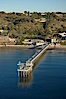 SIO Pier.  The Scripps Institution of Oceanography research pier is 1090 feet long and was built of reinforced concrete in 1988, replacing the original wooden pier built in 1915. The Scripps Pier is home to a variety of sensing equipment above and below water that collects various oceanographic data. The Scripps research diving facility is located at the foot of the pier. Fresh seawater is pumped from the pier to the many tanks and facilities of SIO, including the Birch Aquarium. The Scripps Pier is named in honor of Ellen Browning Scripps, the most significant donor and benefactor of the Institution. Scripps Institution of Oceanography, La Jolla, California, USA. Image #22286