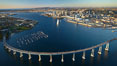 San Diego Coronado Bridge, known locally as the Coronado Bridge, links San Diego with Coronado, California.  The bridge was completed in 1969 and was a toll bridge until 2002.  It is 2.1 miles long and reaches a height of 200 feet above San Diego Bay.  Coronado Island is to the left, and downtown San Diego is to the right in this view looking north. USA