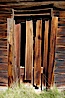 Weathered and broken old door, Kelley Building on Green Street. Bodie State Historical Park, California, USA. Image #23109