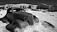 Old car lying in dirt field. Bodie State Historical Park, California, USA. Image #23112