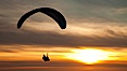 Paraglider soaring at Torrey Pines Gliderport, sunset, flying over the Pacific Ocean. La Jolla, California, USA. Image #24292