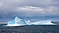 Iceberg, ocean, light and clouds.  Light plays over icebergs and the ocean near Coronation Island. Coronation Island, South Orkney Islands, Southern Ocean. Image #24779