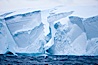 Tabular iceberg.  The edge of a huge tabular iceberg.  Tabular icebergs can be dozens or hundreds of miles in size, have flat tops and sheer sides. Scotia Sea, Southern Ocean. Image #24793