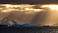 Iceberg, ocean, light and clouds.  Light plays over icebergs and the ocean near Coronation Island. Coronation Island, South Orkney Islands, Southern Ocean. Image #24796