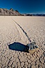 A sliding rock of the Racetrack Playa.  The sliding rocks, or sailing stones, move across the mud flats of the Racetrack Playa, leaving trails behind in the mud.  The explanation for their movement is not known with certainty, but many believe wind pushes the rocks over wet and perhaps icy mud in winter. Racetrack Playa, Death Valley National Park, California, USA. Image #25239