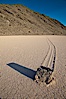 A sliding rock of the Racetrack Playa.  The sliding rocks, or sailing stones, move across the mud flats of the Racetrack Playa, leaving trails behind in the mud.  The explanation for their movement is not known with certainty, but many believe wind pushes the rocks over wet and perhaps icy mud in winter. Racetrack Playa, Death Valley National Park, California, USA. Image #25243