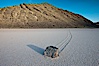 A sliding rock of the Racetrack Playa.  The sliding rocks, or sailing stones, move across the mud flats of the Racetrack Playa, leaving trails behind in the mud.  The explanation for their movement is not known with certainty, but many believe wind pushes the rocks over wet and perhaps icy mud in winter. Racetrack Playa, Death Valley National Park, California, USA. Image #25266