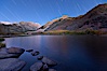 Star trails and alpenglow on the Sierra Nevada, Paiute Peak, before sunrise, reflected in North Lake in the Sierra Nevada. Bishop Creek Canyon Sierra Nevada Mountains, Bishop, California, USA. Image #26053