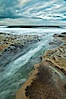 Waves wash over sandstone reef, clouds and sky. La Jolla, California, USA. Image #26341