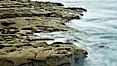 Waves wash over sandstone reef, clouds and sky. La Jolla, California, USA. Image #26345