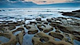 Waves wash over sandstone reef, clouds and sky. La Jolla, California, USA. Image #26346