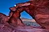 Natural arch formed in sandstone frames the setting moon. Valley of Fire State Park, Nevada, USA. Image #26486