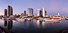 Panoramic photo of San Diego embarcadero, showing the San Diego Marriott Hotel and Marina (center), Roy's Restaurant (center) and Manchester Grand Hyatt Hotel (left) viewed from the San Diego Embarcadero Marine Park. San Diego, California, USA