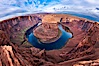 Horseshoe Bend. The Colorado River makes a 180-degree turn at Horseshoe Bend. Here the river has eroded the Navajo sandstone for eons, digging a canyon 1100-feet deep. Horseshoe Bend, Page, Arizona, USA. Image #26602