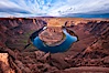 Horseshoe Bend. The Colorado River makes a 180-degree turn at Horseshoe Bend. Here the river has eroded the Navajo sandstone for eons, digging a canyon 1100-feet deep. Horseshoe Bend, Page, Arizona, USA. Image #26635