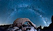 The Milky Way galaxy arcs above Arch Rock, panoramic photograph, cylindrical projection. Joshua Tree National Park, California, USA. Image #26848