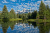The Grand Tetons, reflected in the glassy waters of the Snake River at Schwabacher Landing, on a beautiful summer morning. Grand Teton National Park, Wyoming, USA