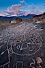 Sky Rock petroglyphs near Bishop, California.  Hidden atop an enormous boulder in the Volcanic Tablelands lies Sky Rock, a set of petroglyphs that face the sky.  These superb examples of native American petroglyph artwork are thought to be Paiute in origin, but little is known about them. Bishop, California, USA. Image #26979