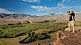 Photographer over Owens River valley, Sierra Nevada mountain range in distance, viewed from Volcanic Tablelands near Bishop, California. Bishop, California, USA. Image #26985